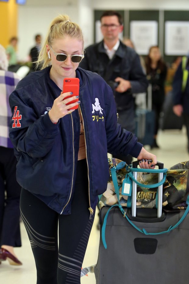 ABERDEEN, SCOTLAND - JUNE 22: Sophie Turner arriving at Aberdeen Airport facetiming Joe Jonas before the wedding of Kit Harrington and Rose Leslie on June 22, 2018 in Aberdeen, Scotland. (Photo by Mark Milan/GC Images)