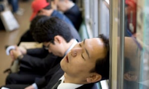 A commuter sleeps on the Tokyo subway.