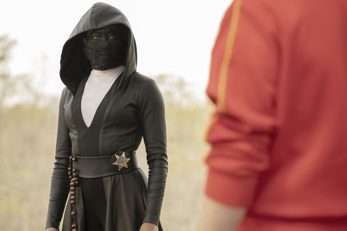 Masked vigilante Sister Night (Regina King) stares down an unknown character.