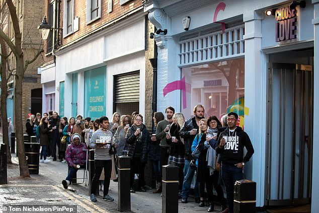 Queues: Crowds who were gathered outside the Covent Garden store were handed cups of coffee to thank them for the generosity