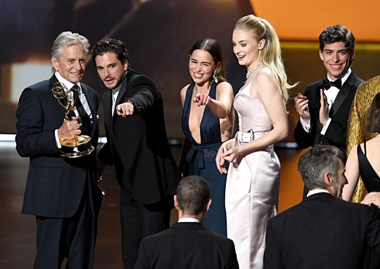 LOS ANGELES, CALIFORNIA - SEPTEMBER 22: Michael Douglas presents the Outstanding Drama Series award for 'Game of Thrones' to Kit Harington, Emilia Clarke, and Sophie Turner onstage during the 71st Emmy Awards at Microsoft Theater on September 22, 2019 in Los Angeles, California. (Photo by Jeff Kravitz/FilmMagic)