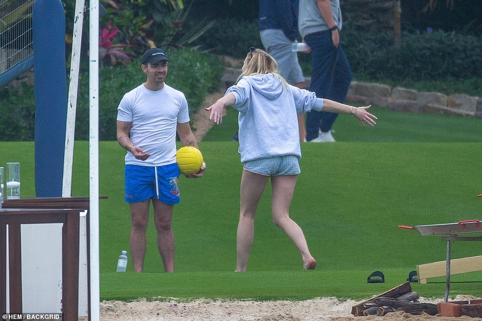Having a ball! Sophie playfully flung her arms out as Joe pulled out a volleyball