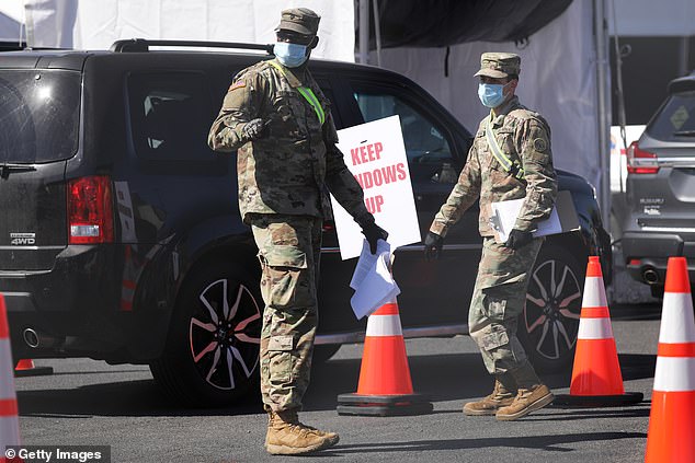 Members of the National Guard communicate with individuals at a newly opened Coronavirus testing site in Brooklyn on April 11