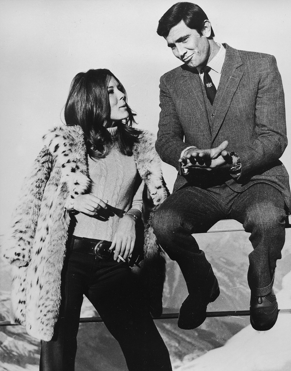 FILE - In this Jan. 10, 1969 file photo, Sean Connery's replacement as James Bond, George Lazenby is pictured with British actress Diana Rigg. The two are captured during takes of "On Her Majesty's Secret Service" at Schilthorn near Muerren, Switzerland. Actress Diana Rigg, who became a 1960s style icon as secret agent Emma Peel in TV series “The Avengers,” has died at age 82. Rigg’s agent Simon Beresford says she died Thursday Sept. 10, 2020 at home with her family. (AP Photo/Bob Dear, File)