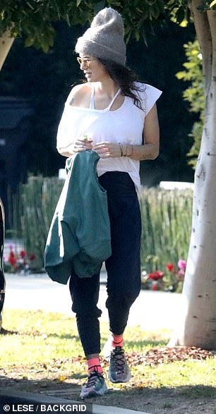 Layers: Lena also wore a floating white top and carried a jumper