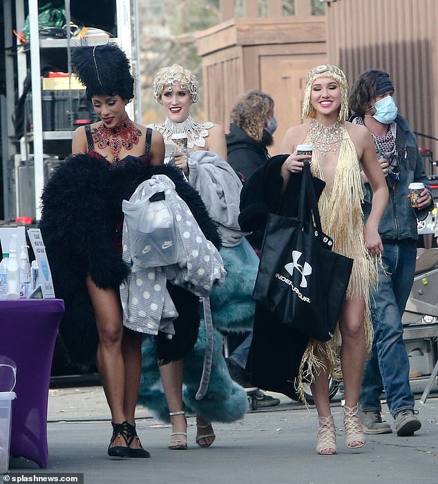 Racy: Some scantily-clad extras were also seen heading to set on the burlesque film