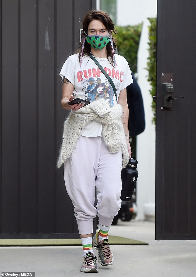 Casual: Lena seemed to be focused on comfort, so she paired her low-key T-shirt with some eggshell-colored sweatpants and white-and-mauve trainers with tall multicolored socks