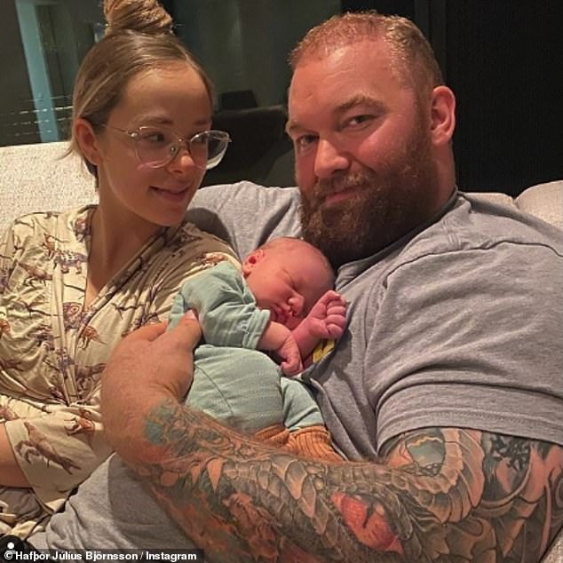 Doting dad: Hafthor welcomed his son Stormur Magni with his wife Kelsey Henson, 30, in September last year