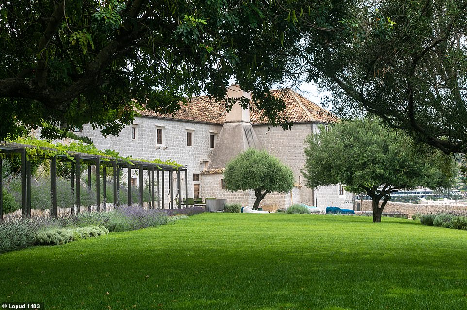 In the medicinal herb garden, pictured, wide lawns have been created, dotted with olive and lemon trees and intersected by a gravel path and a long pergola