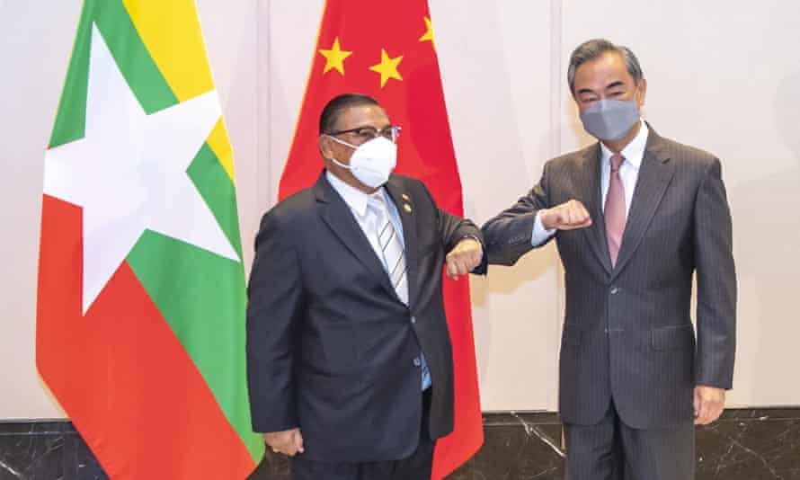 Chinese Foreign Minister Wang Yi at right bumps elbows with with Myanmar’s Foreign Minister U Wunna Maung Lwin during one of the meetings marking the 30th anniversary of formal relations between China and ASEAN on 8 June, 2021.