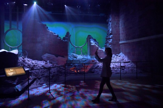 A woman takes a picture of 'The Destroyed Throne Room' set from the TV show Game of Thrones during the media preview day for the opening of the new Game of Thrones studio tour at Linen Mill Studios in Banbridge, Northern Ireland, February 2, 2022. REUTERS/Clodagh Kilcoyne