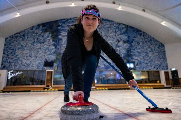 LancsLive reporter Denise Evans has a go at 'pushing off' a stone in curling