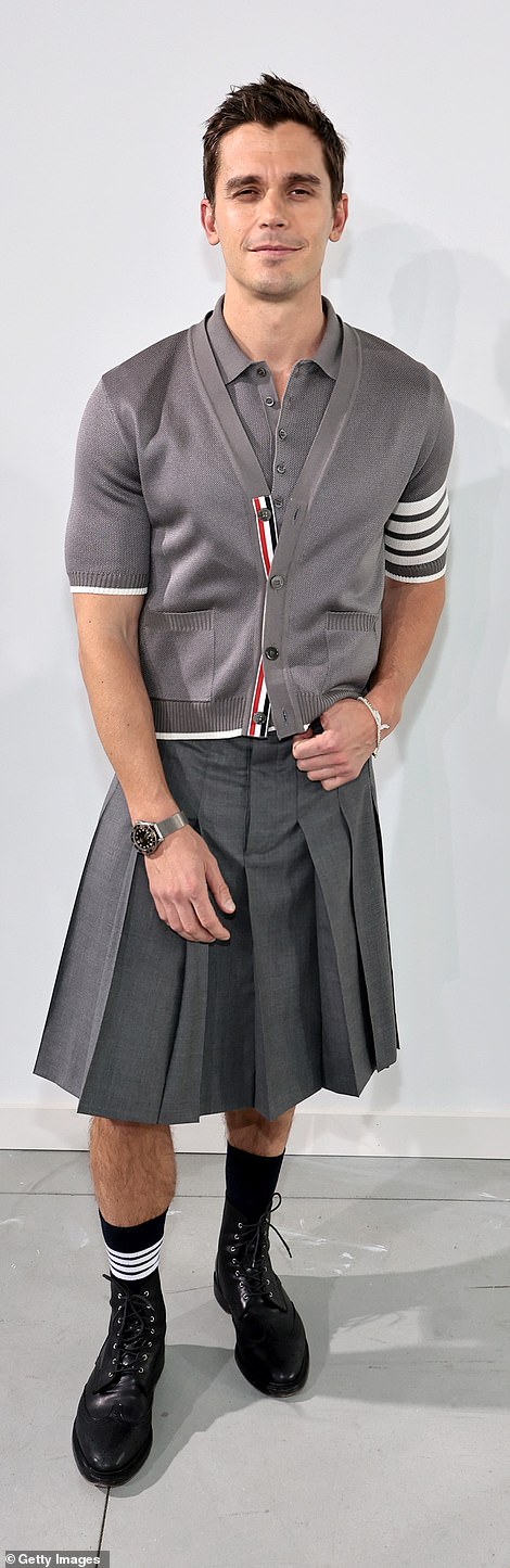 Contrasts: Queer Eye star Antoni Porowski also showed off his trim legs, though he wore a charcoal pleated skirt with a gray striped cardigan and a shirt in the same shade, plus black boots