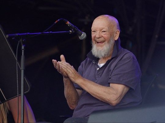 A photo of Michael Eavis on stage at Glastonbury festival.