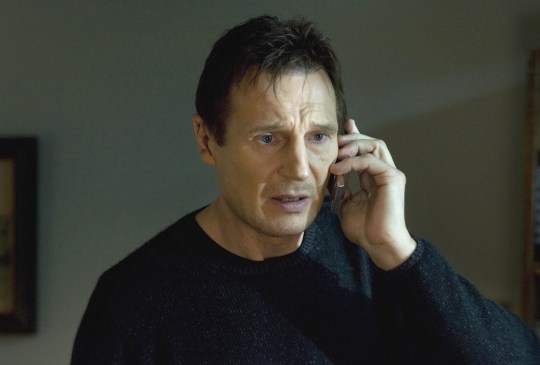 Liam Neeson clutching a phone in Taken