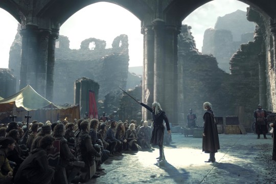 Matt Smith as Daemon Targaryen and Emma D'Arcy as Rhaenyra Targaryen in House of the Dragon surroued by other people